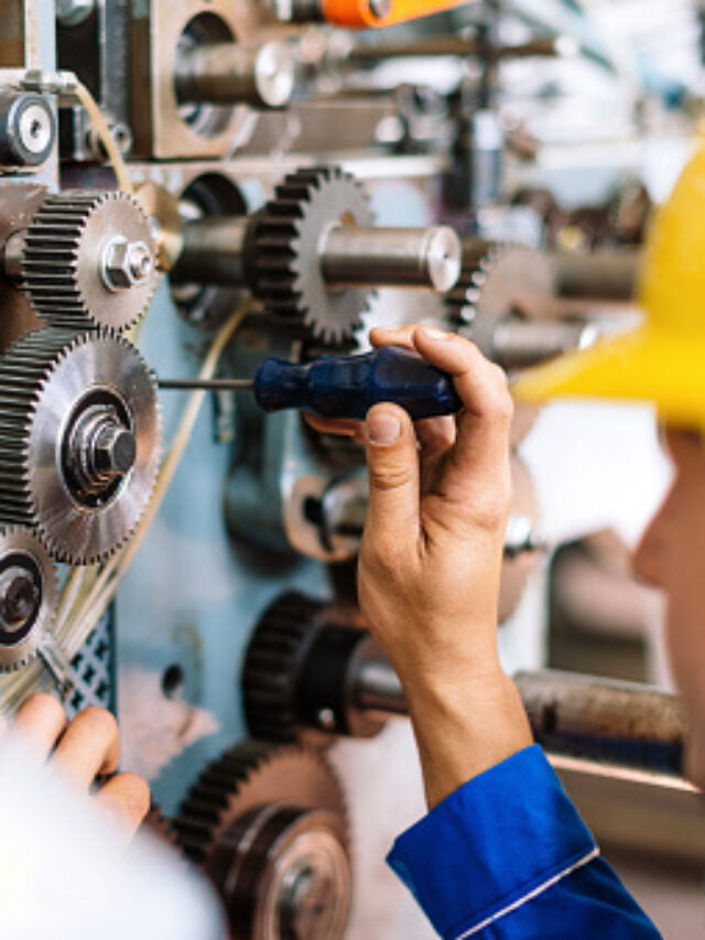 Machinist precisely setting up cog wheels